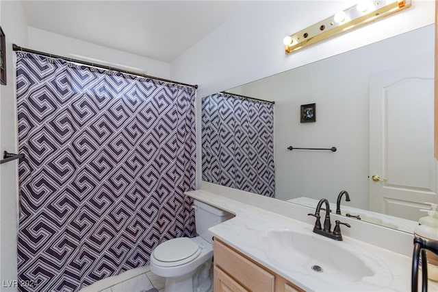 bathroom with vanity, toilet, and tile patterned floors