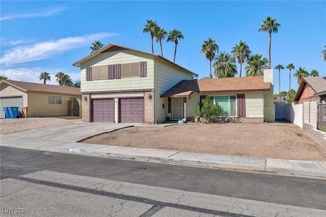 4020 Shadow Wood Ave, Las Vegas, NV 89121 - view of front facade with fence, driveway, an attached garage, and brick siding