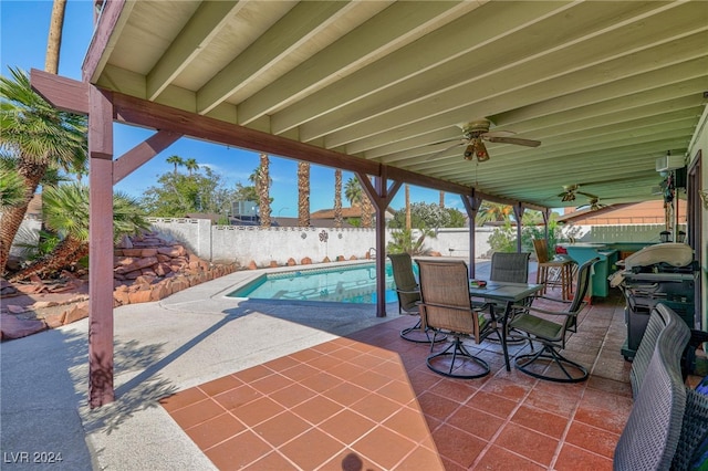 view of patio / terrace with a fenced in pool, ceiling fan, and a grill