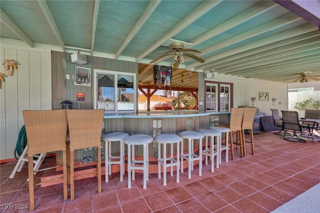 view of patio featuring an outdoor bar and ceiling fan