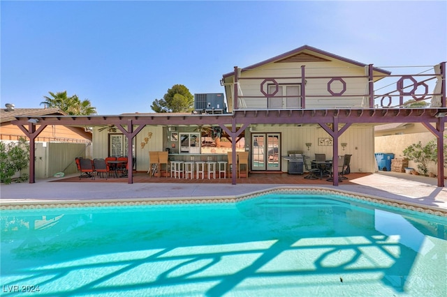 view of pool featuring cooling unit and a patio