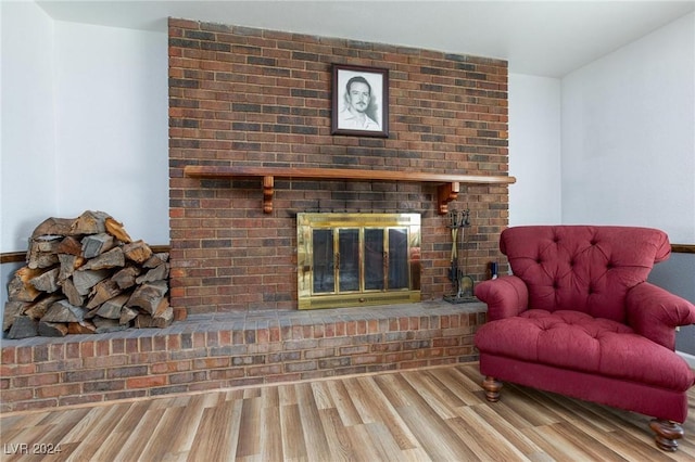 4020 Shadow Wood Ave, Las Vegas, NV 89121 - living area with a brick fireplace and wood finished floors