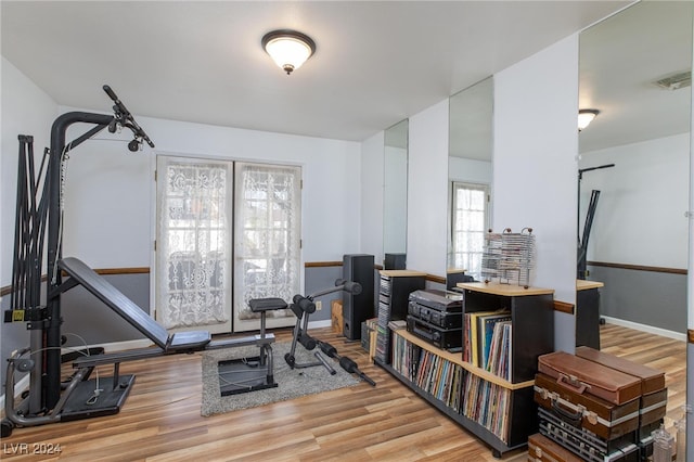 exercise room with hardwood / wood-style floors