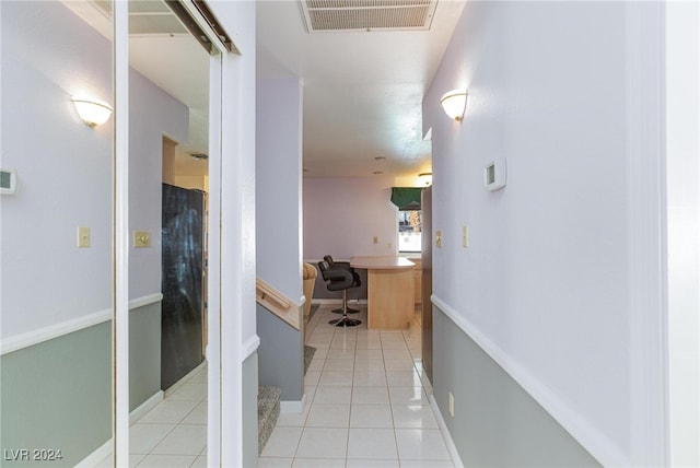 corridor featuring light tile patterned flooring