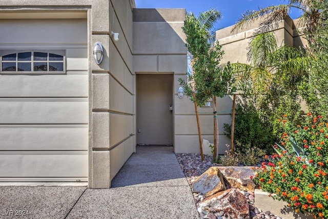 entrance to property featuring stucco siding