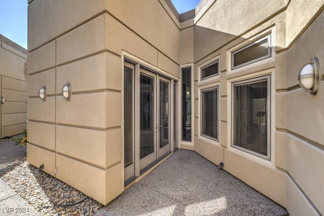 doorway to property with french doors and stucco siding