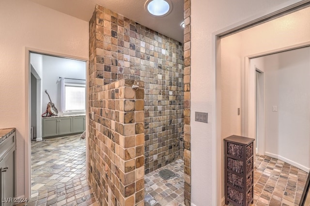 full bathroom with a tile shower