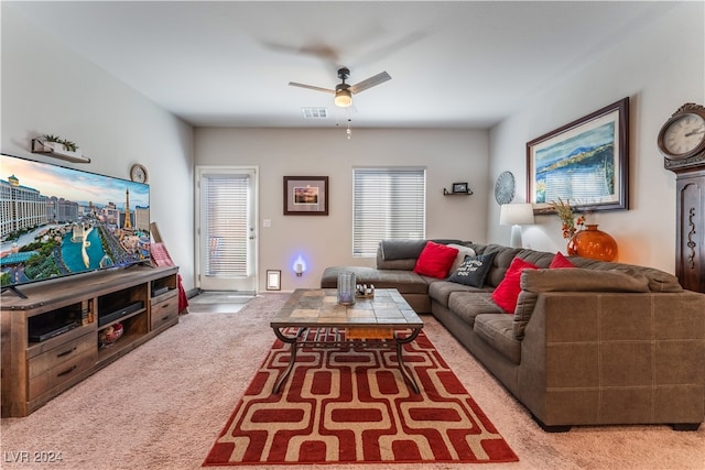 living room with ceiling fan and light colored carpet