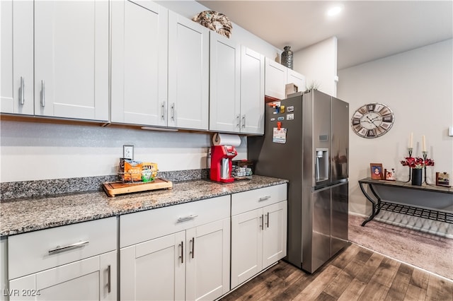 kitchen featuring white cabinets, stainless steel refrigerator with ice dispenser, light stone countertops, and dark hardwood / wood-style floors