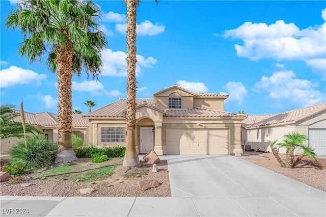 mediterranean / spanish-style home with a garage