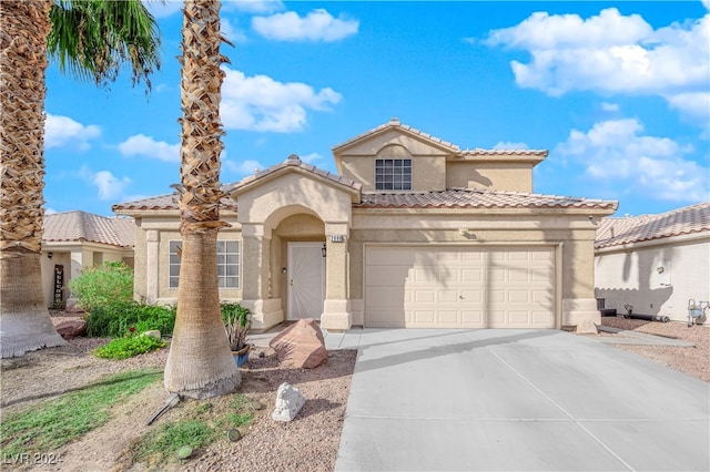 mediterranean / spanish-style home featuring a garage