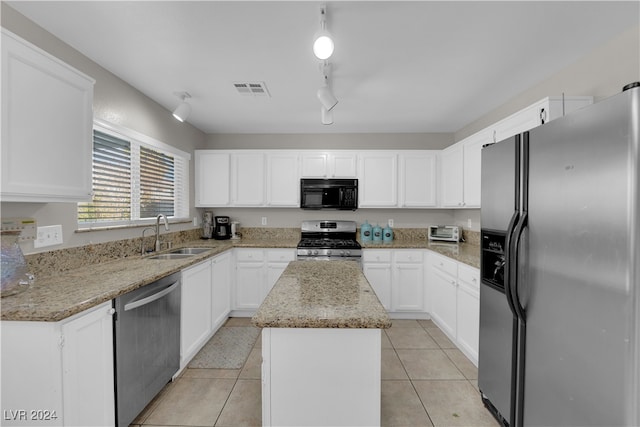 kitchen featuring a kitchen island, sink, stainless steel appliances, and white cabinetry