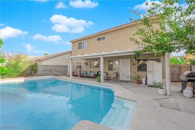 view of swimming pool featuring a grill and a patio area