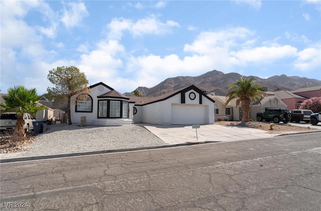 view of front of house featuring a garage and a mountain view