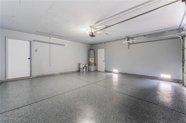 garage featuring a garage door opener and water heater