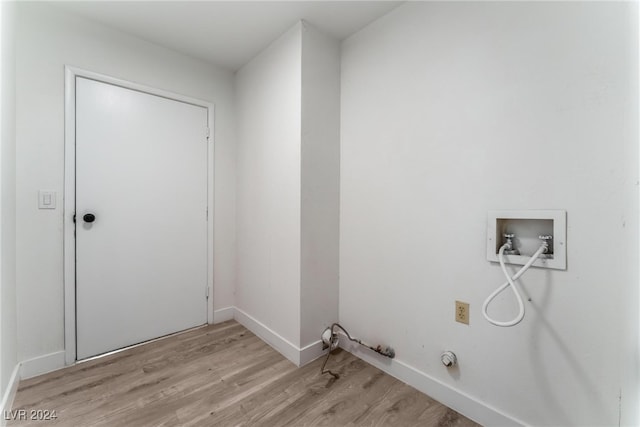 laundry room with hookup for a washing machine, light hardwood / wood-style floors, and gas dryer hookup