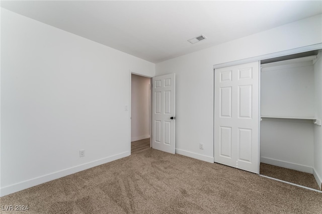 unfurnished bedroom featuring a closet and carpet floors