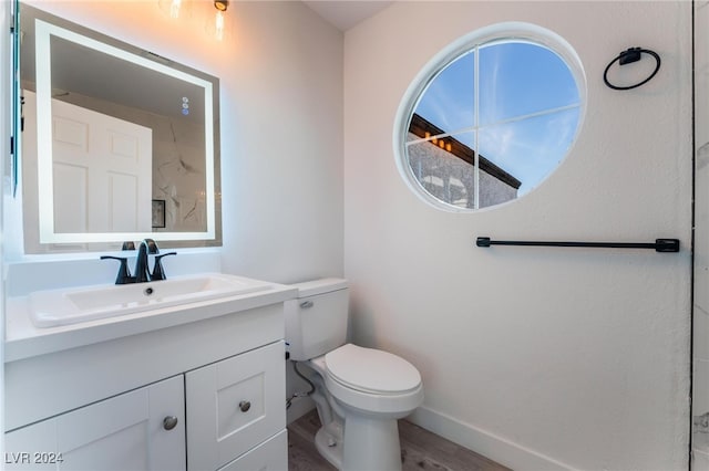 bathroom featuring hardwood / wood-style flooring, vanity, and toilet