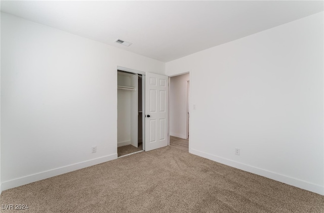 unfurnished bedroom featuring a closet and carpet