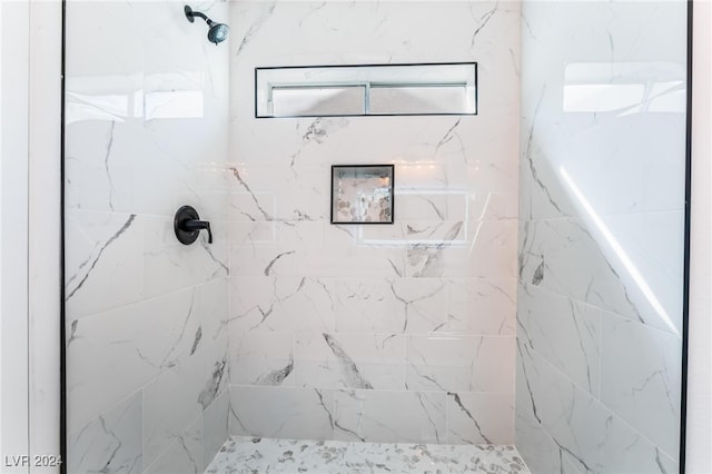 bathroom with tiled shower