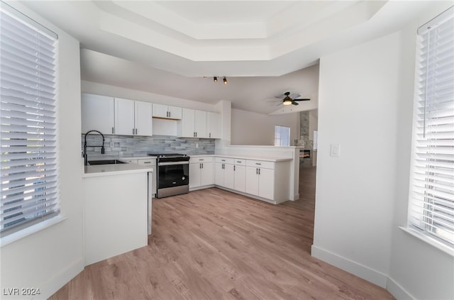 kitchen featuring white cabinets, stainless steel electric range, a wealth of natural light, and sink