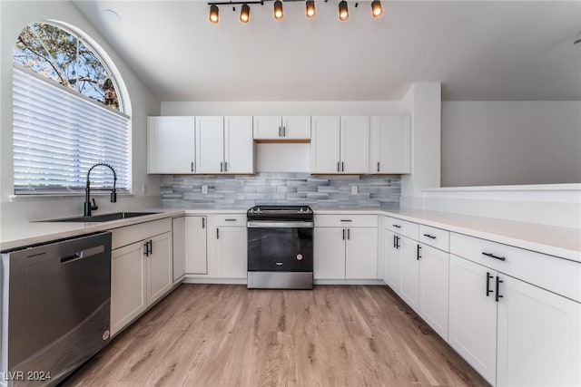 kitchen featuring stainless steel appliances, white cabinetry, and sink