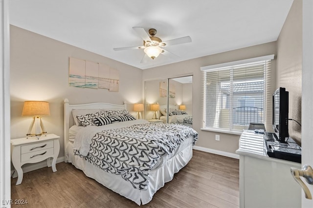 bedroom with a closet, dark hardwood / wood-style floors, and ceiling fan