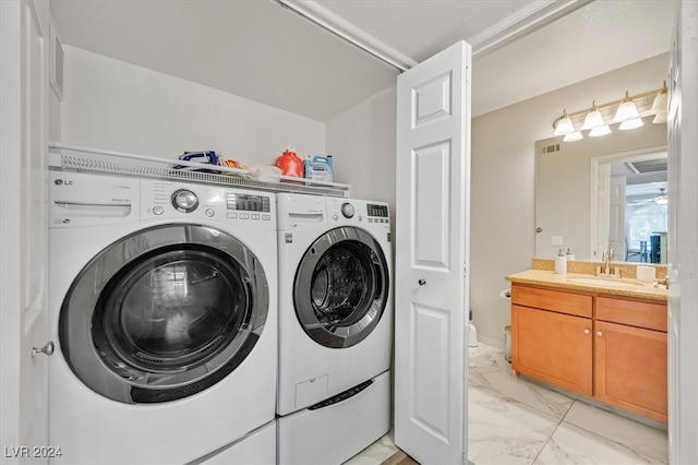 washroom featuring separate washer and dryer and sink