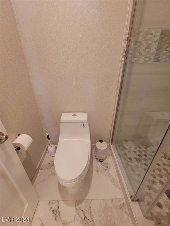 bathroom with walk in shower and toilet