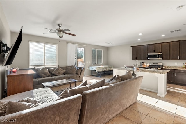 living room with ceiling fan and light tile patterned floors