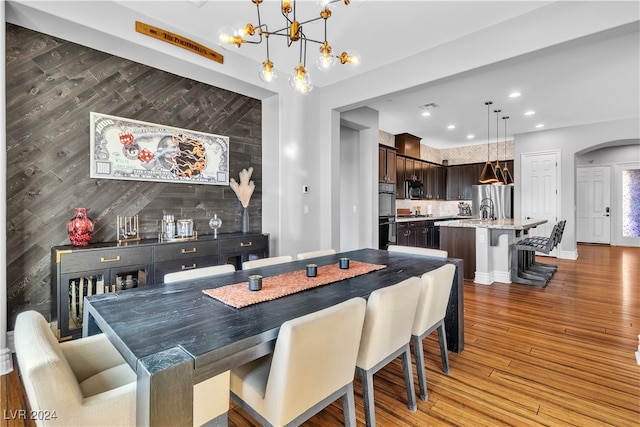 dining space featuring an inviting chandelier and dark hardwood / wood-style flooring