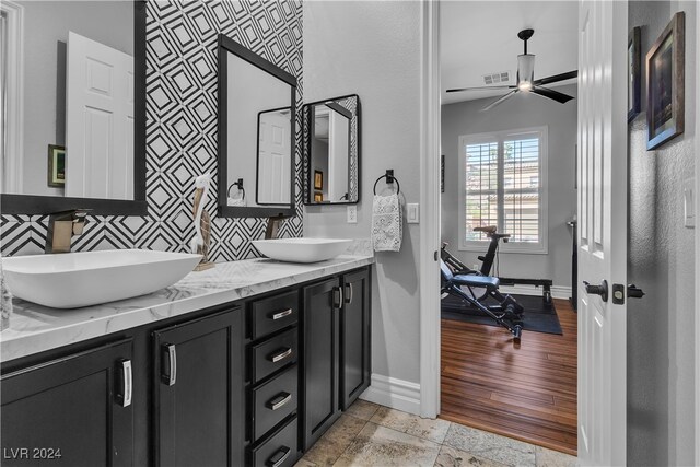 bathroom featuring vanity, wood-type flooring, backsplash, and ceiling fan