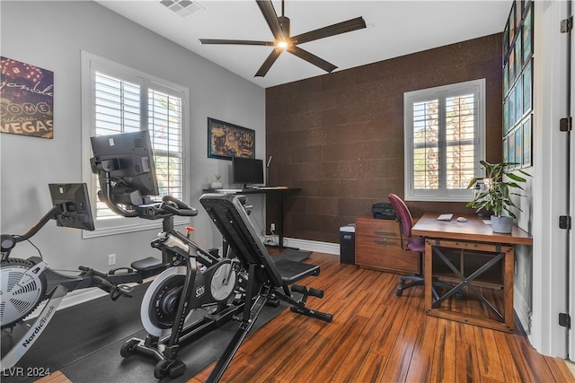 exercise room featuring hardwood / wood-style floors, ceiling fan, and a wealth of natural light