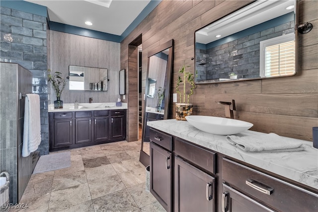 bathroom featuring vanity and wood walls