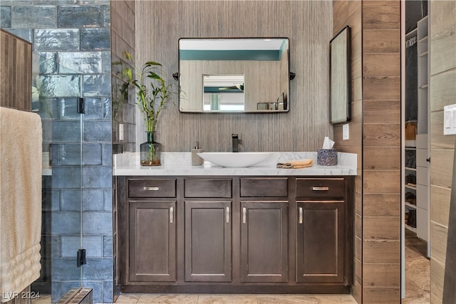 bathroom featuring vanity and tile walls