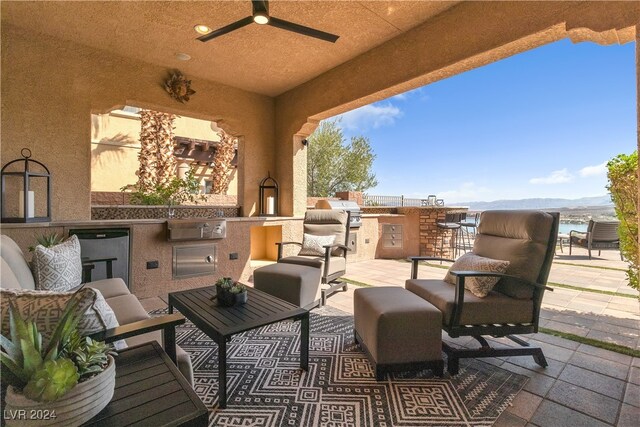 view of patio / terrace with an outdoor living space, area for grilling, sink, and ceiling fan