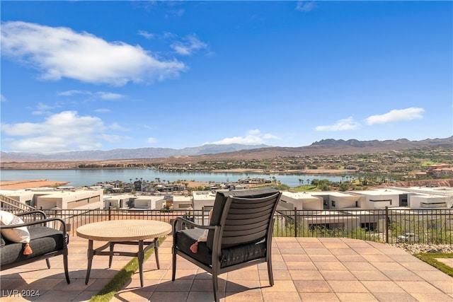 view of patio with a water and mountain view