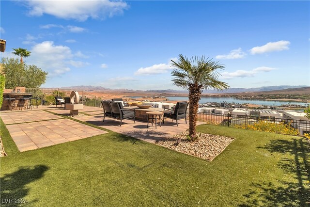 view of yard featuring a patio and a water and mountain view