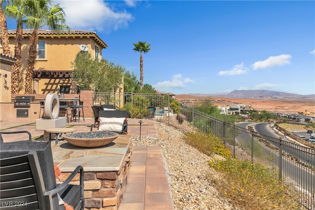 view of patio with a mountain view and grilling area