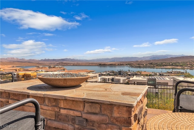 view of patio with a water and mountain view