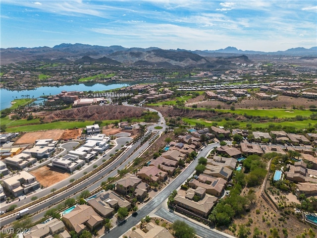 birds eye view of property with a water and mountain view