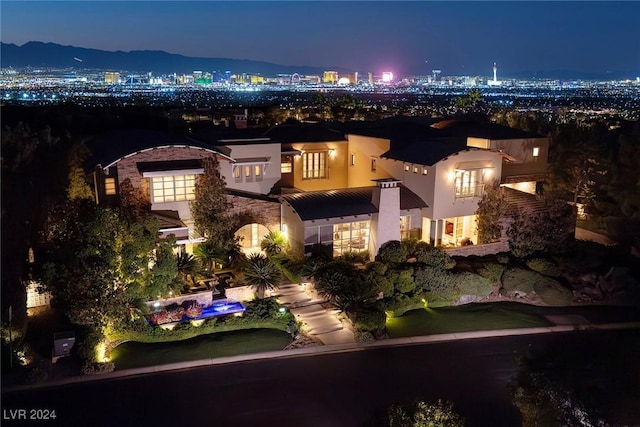 aerial view at twilight featuring a mountain view