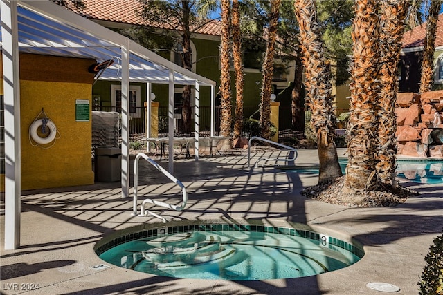 view of pool with a patio area and a community hot tub