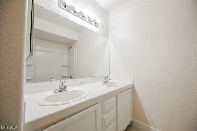 bathroom featuring vanity and a shower