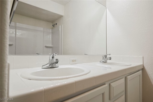 bathroom with vanity and walk in shower