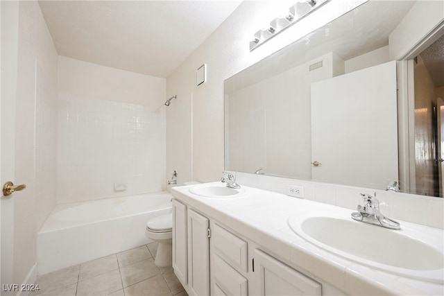 full bathroom with toilet, tiled shower / bath, vanity, and tile patterned flooring