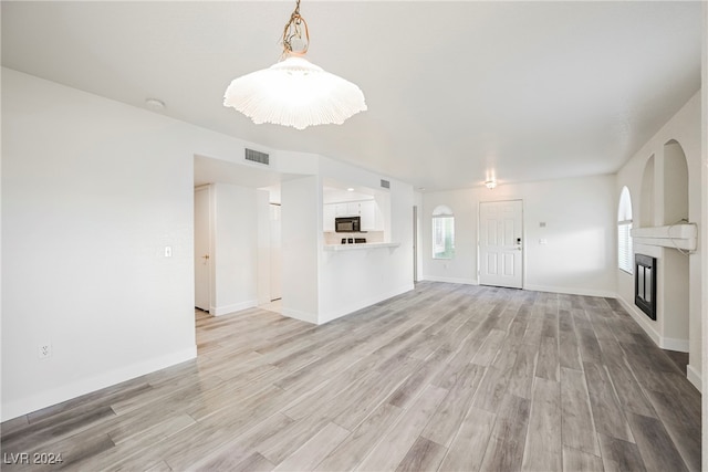 unfurnished living room featuring light wood-type flooring