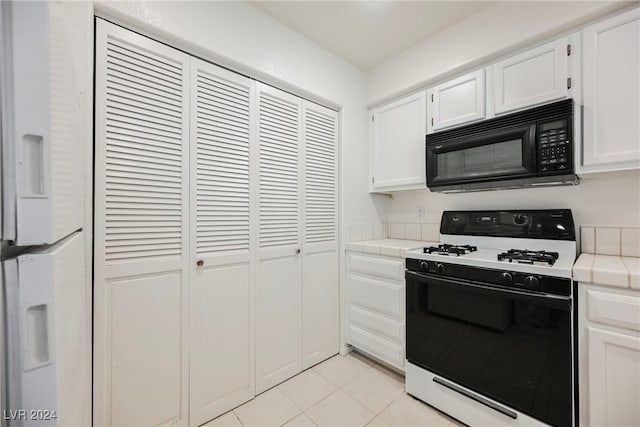 kitchen featuring tile countertops, white cabinetry, white appliances, and light tile patterned floors