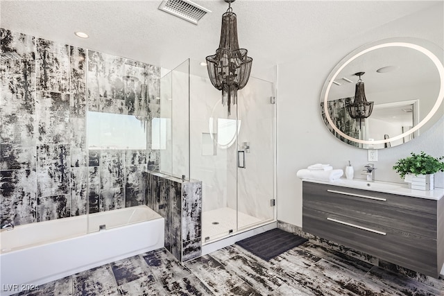 bathroom featuring vanity, independent shower and bath, a textured ceiling, and an inviting chandelier