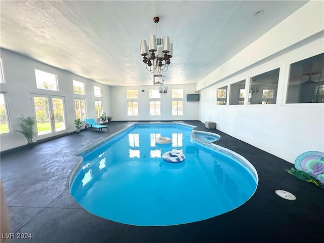 view of swimming pool with an inviting chandelier